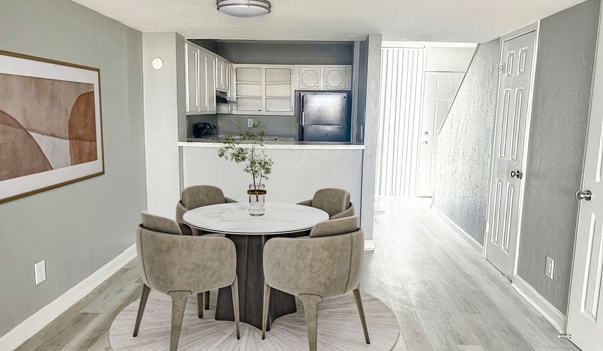 A dining room featuring a round table surrounded by several chairs, creating an inviting atmosphere for meals at Cliffside at Mountain Park in El Paso, Texas