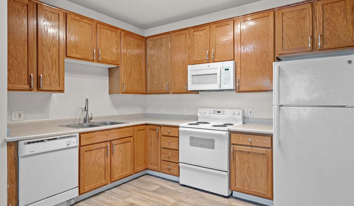 Kitchen with white appliances at Chinook Way Apartments in Fairview, Oregon