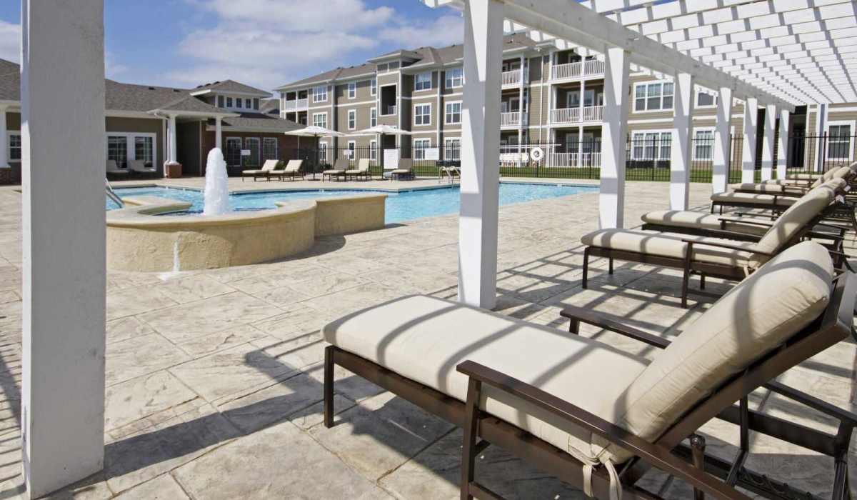Pool with lounge beds at Burkart Crossing Apartments in Seymour, Indiana