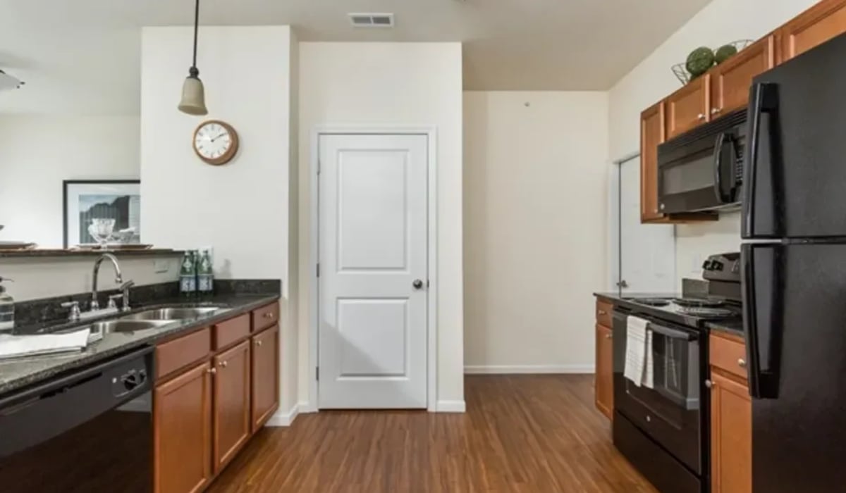Kitchen with wood-style flooring at Burkart Crossing Apartments in Seymour, Indiana
