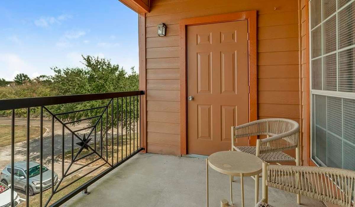 Private balcony with chairs at Settlers Ranch Apartments in Houston,Texas
