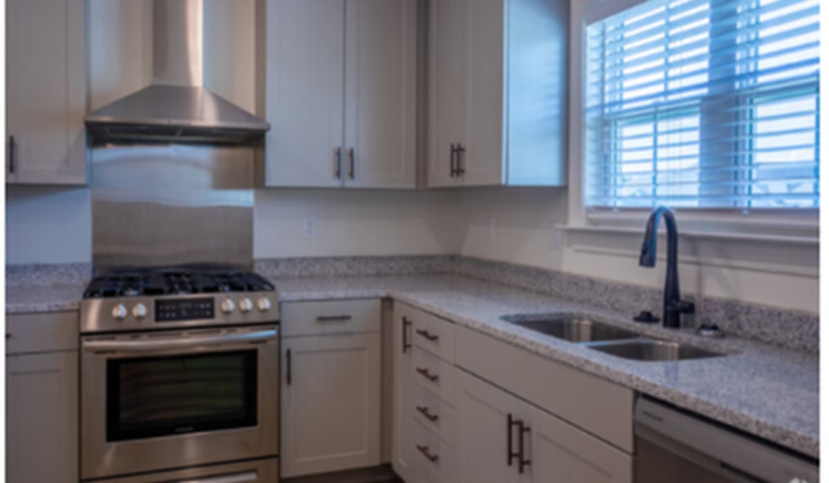 Kitchen with wooden cabinets at Cottages of Schillinger Pointe in Mobile, Alabama