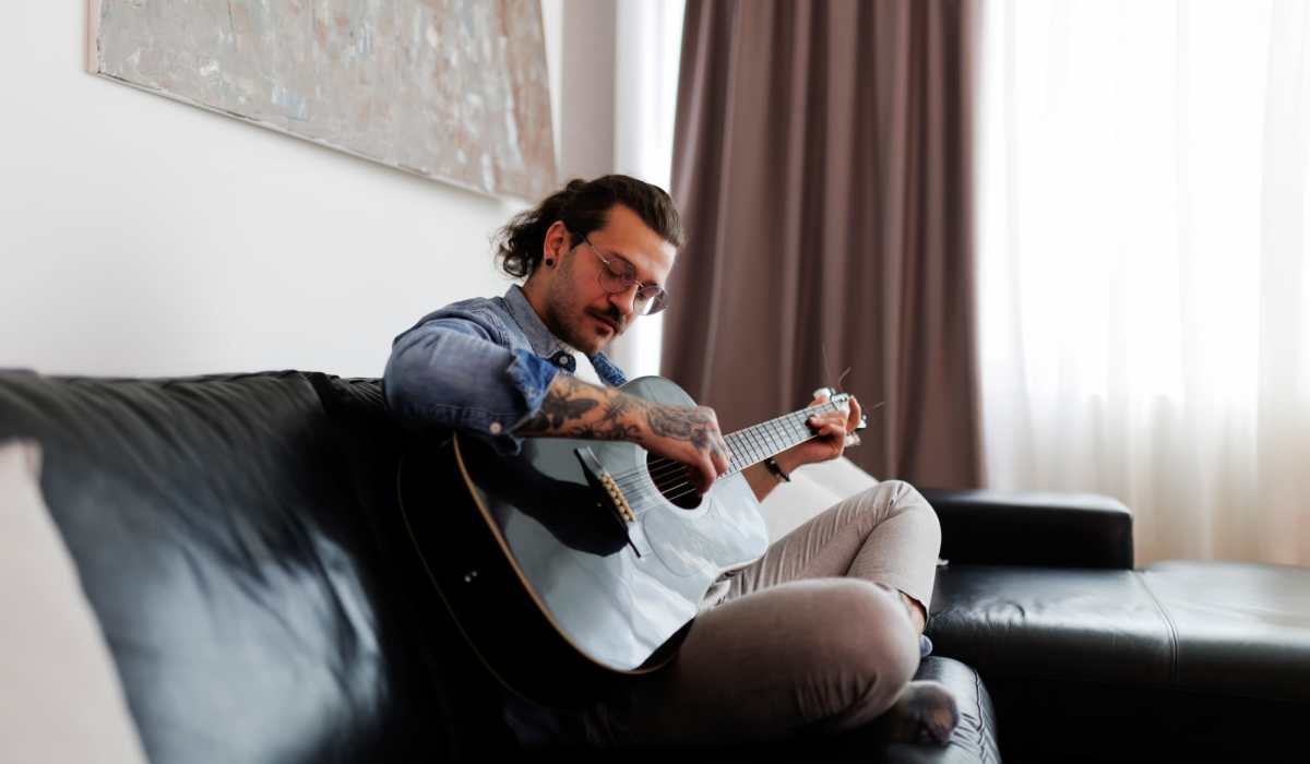 Man playing guitar at Landry Commons in Lafayette,Louisiana