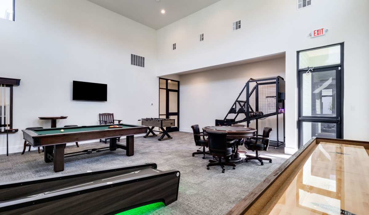 Game room with pool table, skee ball and shuffle board at Trinity Villas in Lafayette, Louisiana