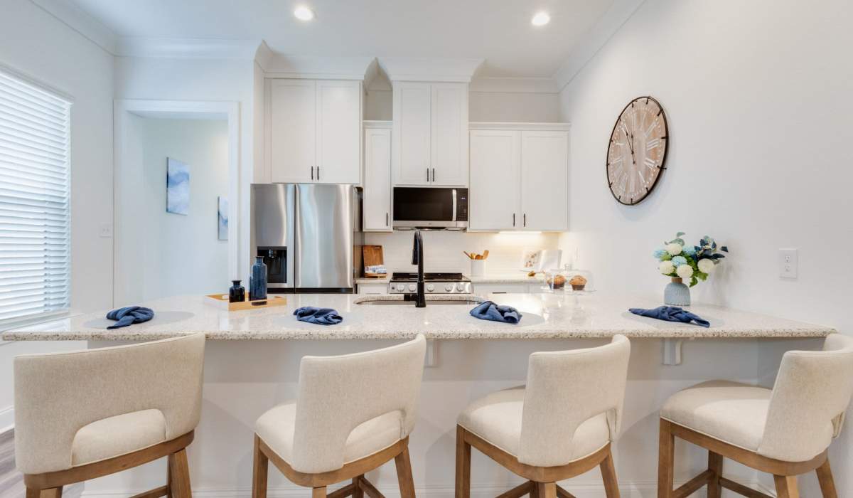 Kitchen with refrigerator and granite countertops Trinity Villas in Lafayette, Louisiana