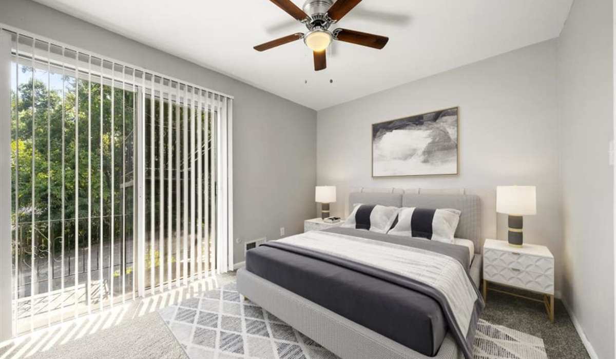 Bedroom with a ceiling fan at Georgian Oaks Apartments in Smyrna, Georgia