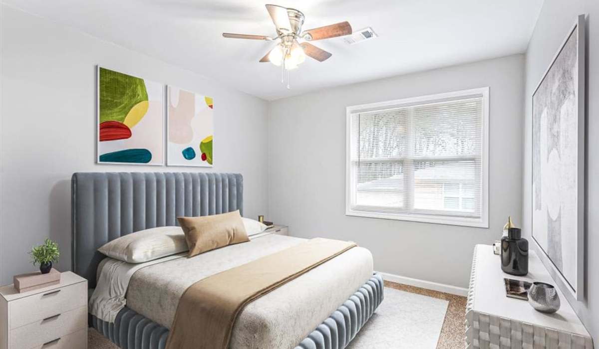 Bedroom with large windows at Georgian Oaks Apartments in Smyrna, Georgia