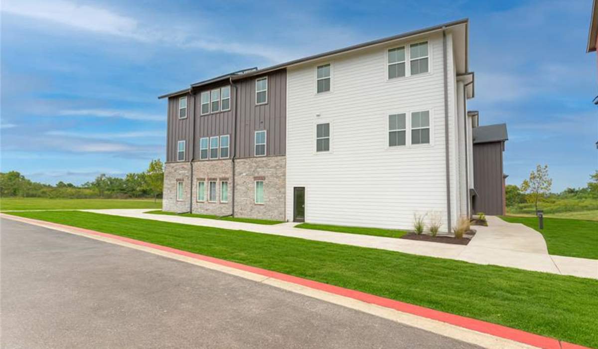 Apartment exterior with car parking space in front at Pure Lowell Apartments in Lowell, Arkansas