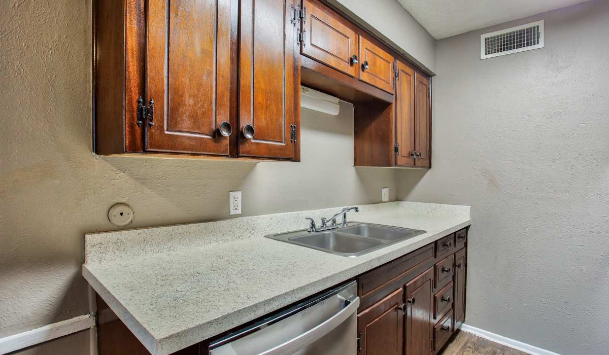 Kitchen with dishwasher at Hurst Gardens in Hurst, Texas