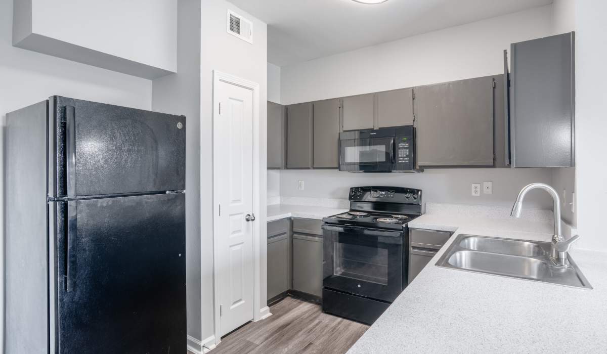 Kitchen with steel dishwasher at Stoneleigh Corpus Christi in Corpus Christi, Texas