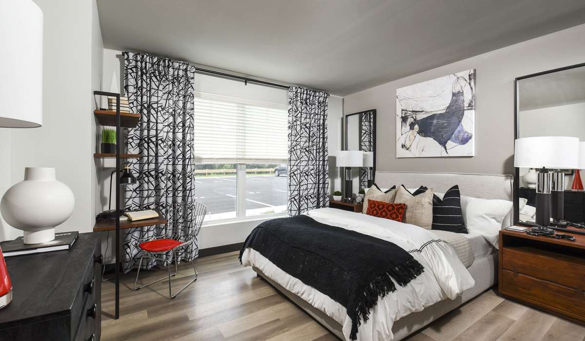 Bedroom with a bright window at J Woburn Heights in Woburn, Massachusetts
