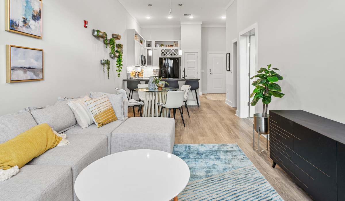 View of white kitchen from living room Kitchen Bar and Living Room with brown leather chair at at Keystone Mebane Towne Center in Mebane, North Carolina