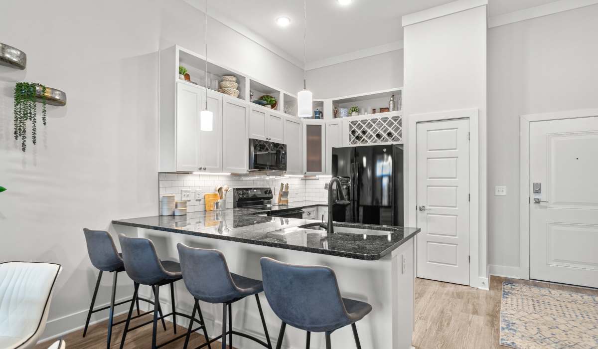  Kitchen Bar and Living Room with brown leather chair at Kitchen view from bar with four blue chairs Keystone Mebane Towne Center in Mebane, North Carolina
