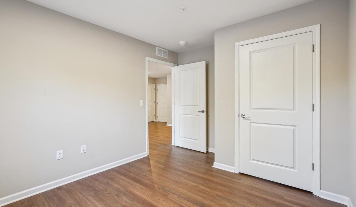 Empty bedroom with wood-style flooring and neutral walls at Alley Landing in Des Moines, Iowa