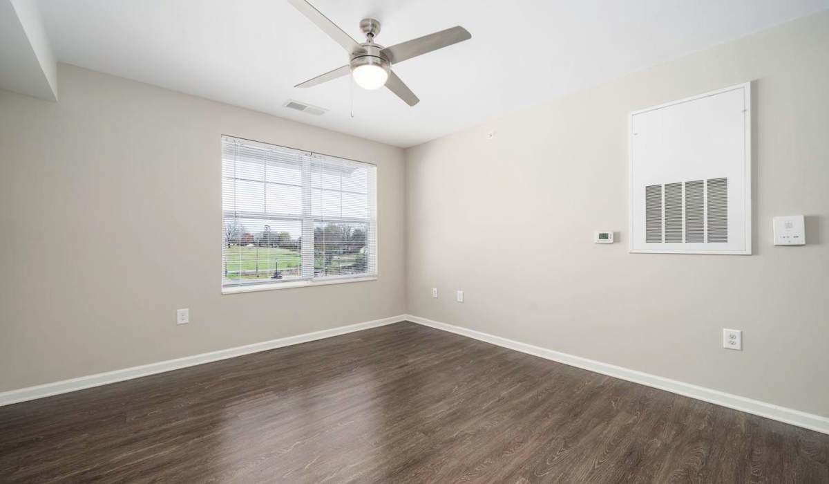Spacious living room with wood-style flooring and large window at Landon Greene in Statesville, North Carolina