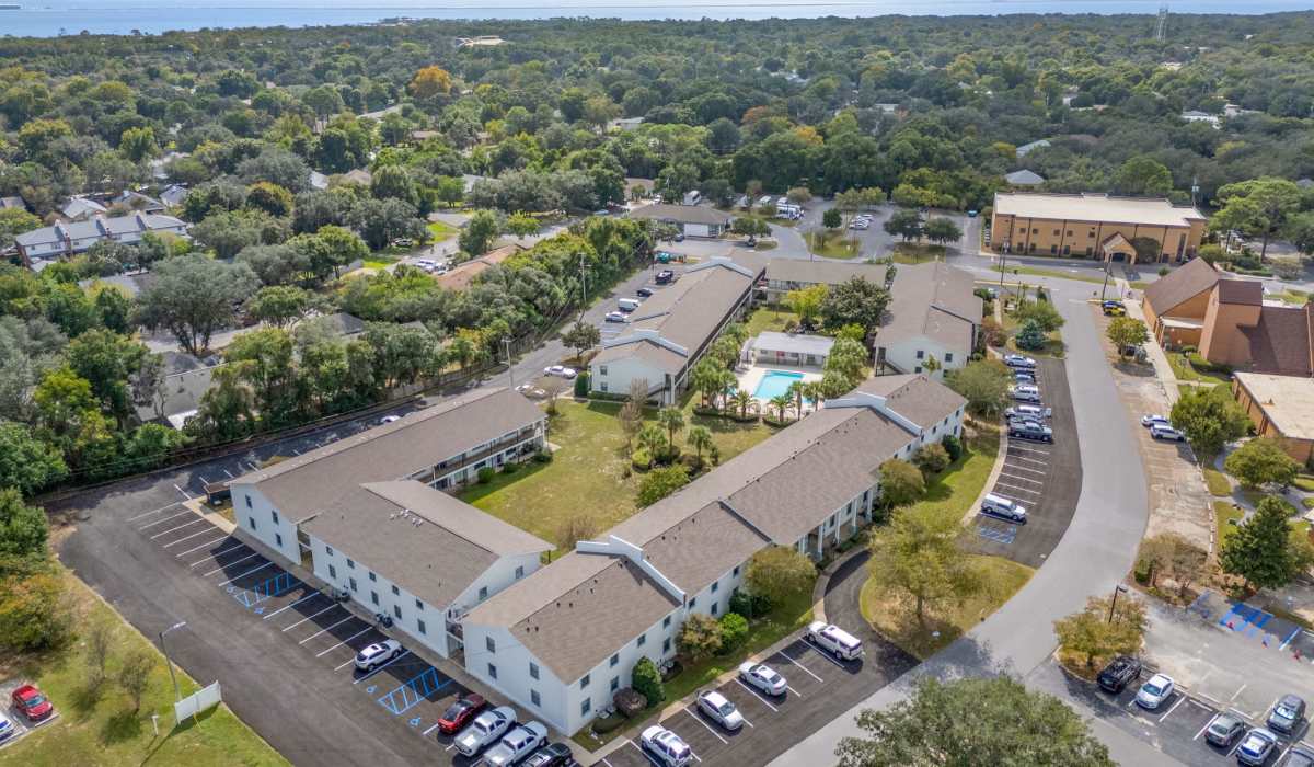 Aerial view of apartment community with pool at Breeze Apartments in Gulf Breeze, Florida