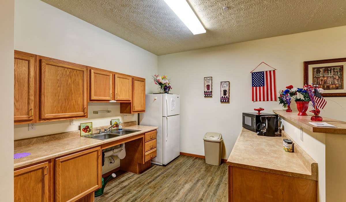 Granite countertops in warm wood kitchen at Beaumont Greene Senior Living in Athens, Ohio