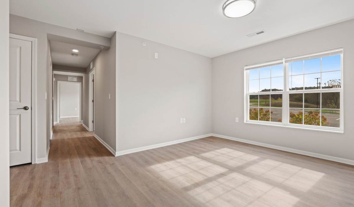 Spacious living room with large windows at Kershaw Greene IV in Athens, Ohio 