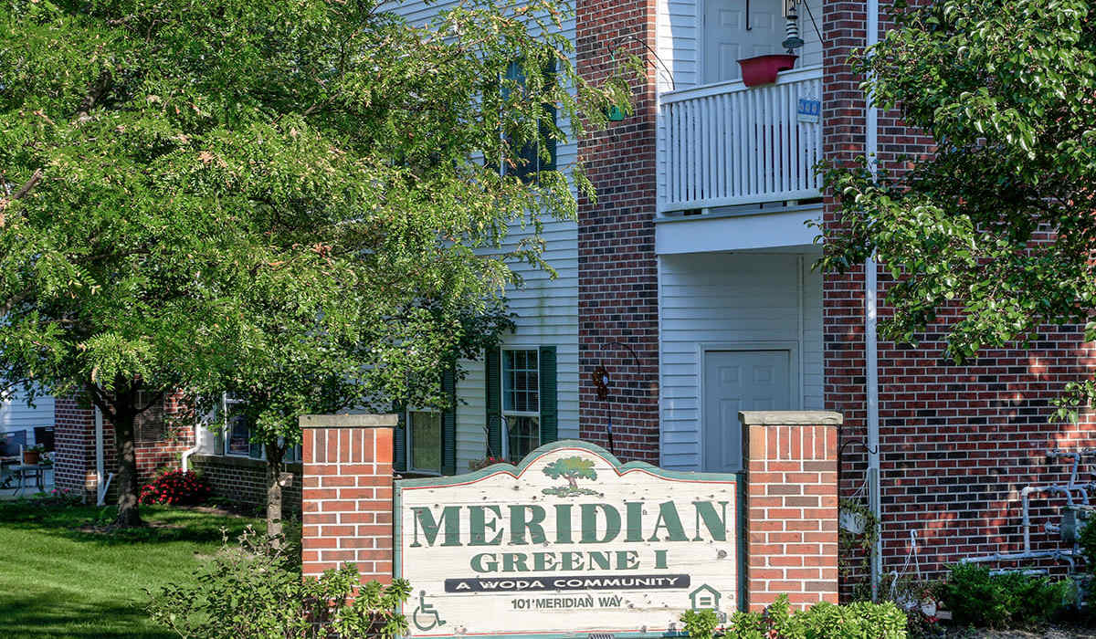 Community sign at apartment entrance at Meridian Greene I in Wintersville, Ohio