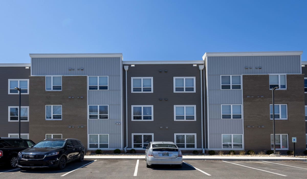 Building exterior with parking slots at Munson Crossing in Zanesville, Ohio 