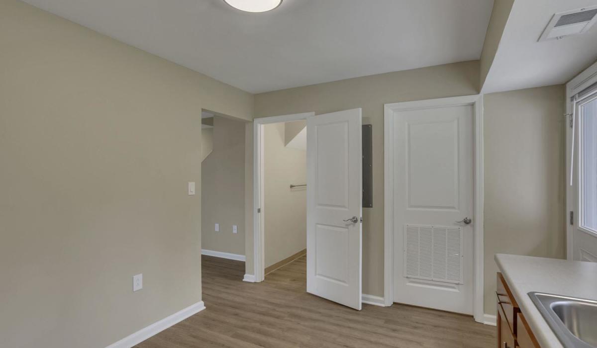 Open layout with wood-style flooring at Plumly Townhomes in Barnesville, Ohio
