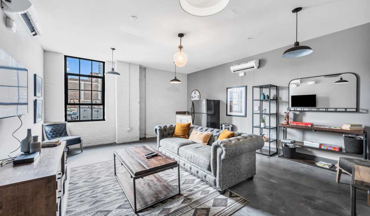 Living room with a TV and air conditioning at Prospect Yard in Cleveland, Ohio 