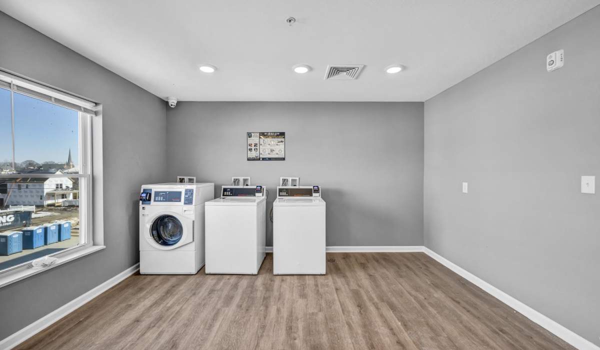 Wood-style flooring in laundry room at Newton Family Apartments in Canton, Ohio
