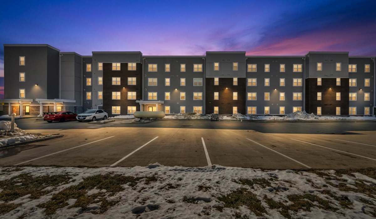 Building exterior with parking lot at Newton Family Apartments in Canton, Ohio