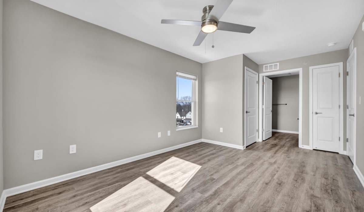 Spacious bedroom with wood-style flooring at Newton Family Apartments in Canton, Ohio