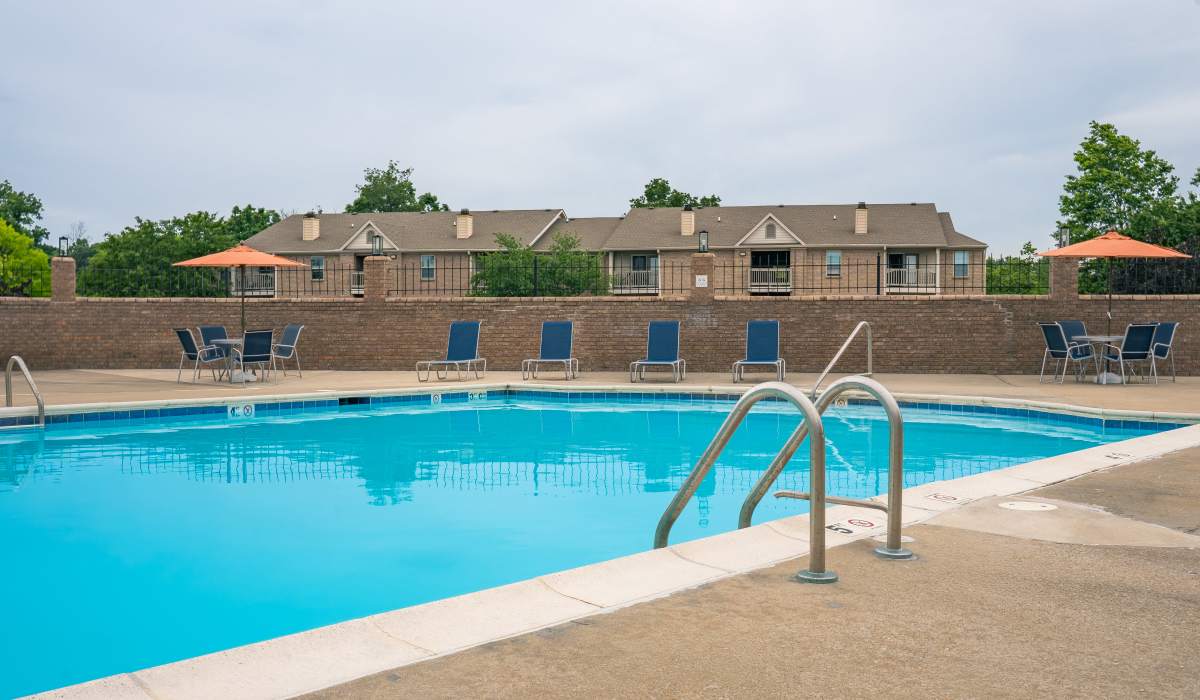 Sparkling pool with lounge chairs at Burlington Oaks in Burlington, Kentucky