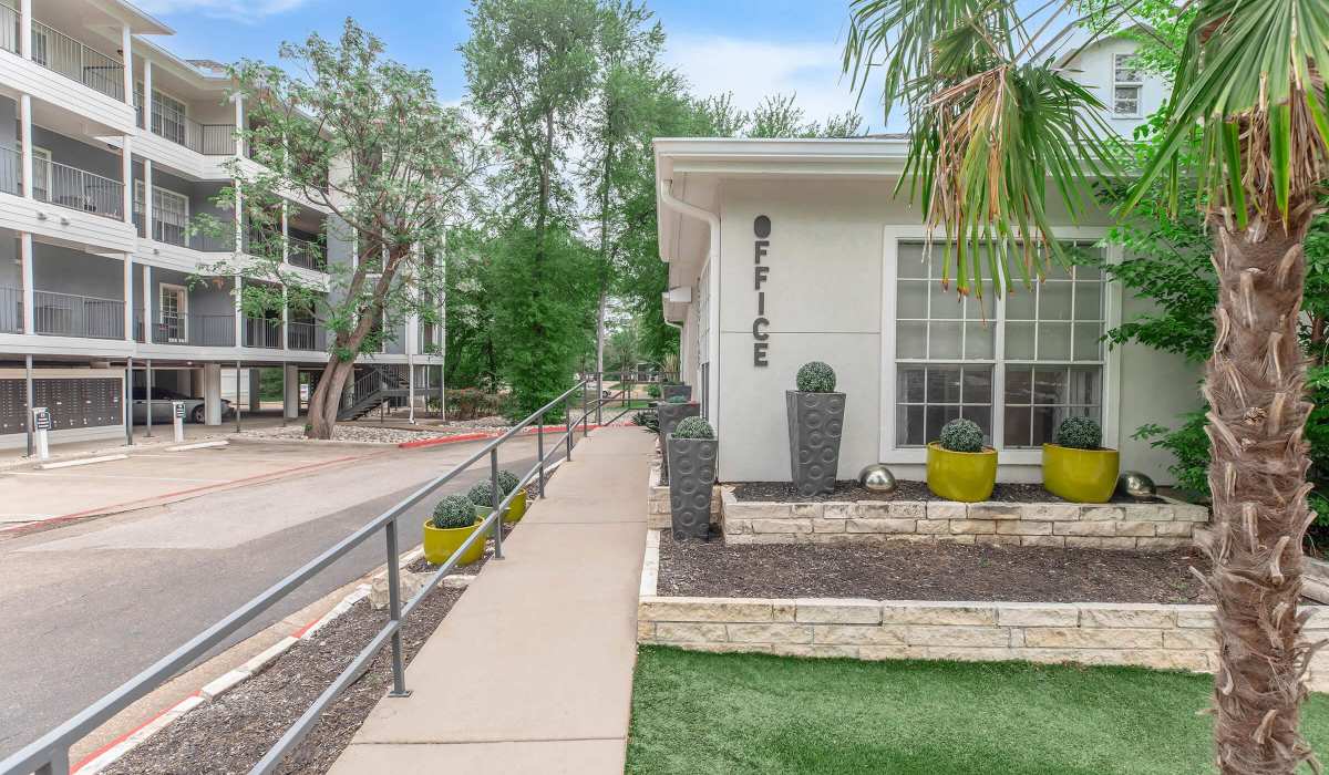 Modern walking path leading to office entrance at The Element in Bryan, Texas