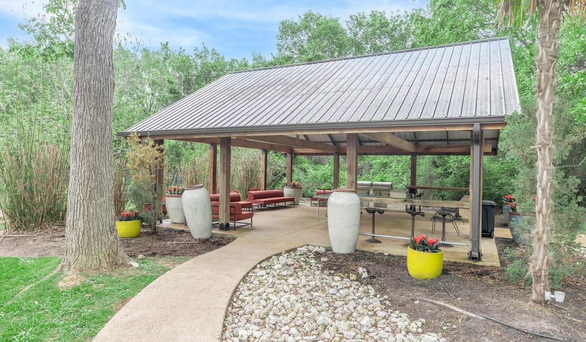 Modern green foliage surrounds a covered seating area at The Element in Bryan, Texas