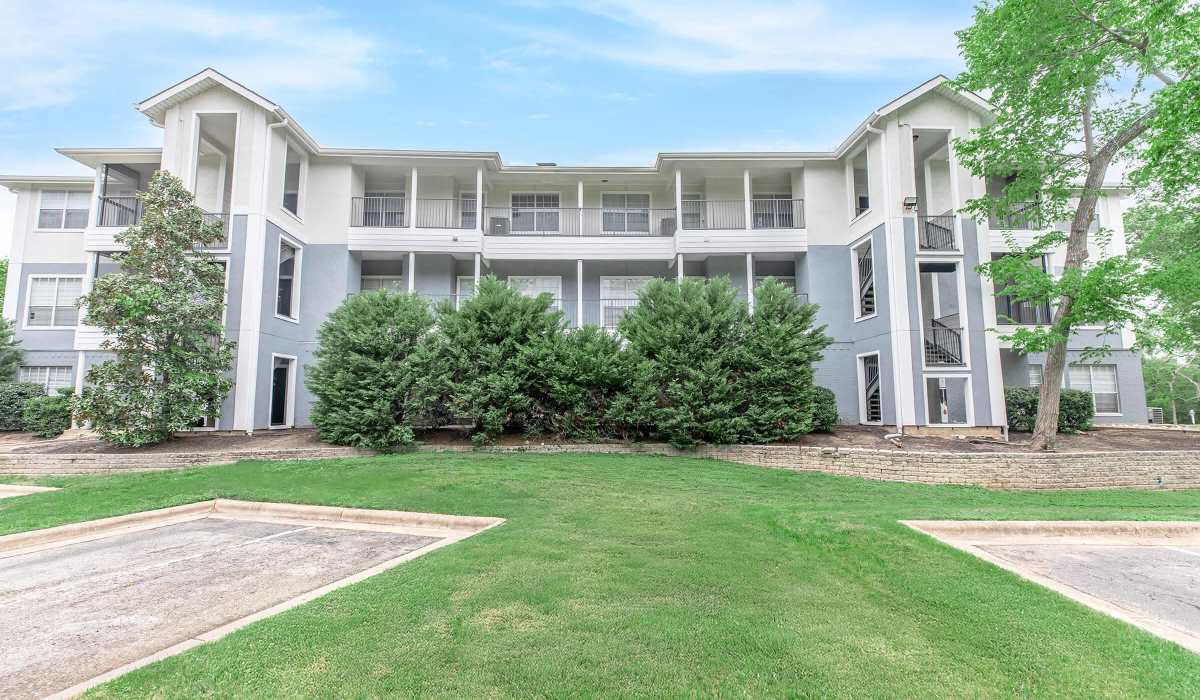 Upgraded green shrubs in front of a three-story building at The Element in Bryan, Texas