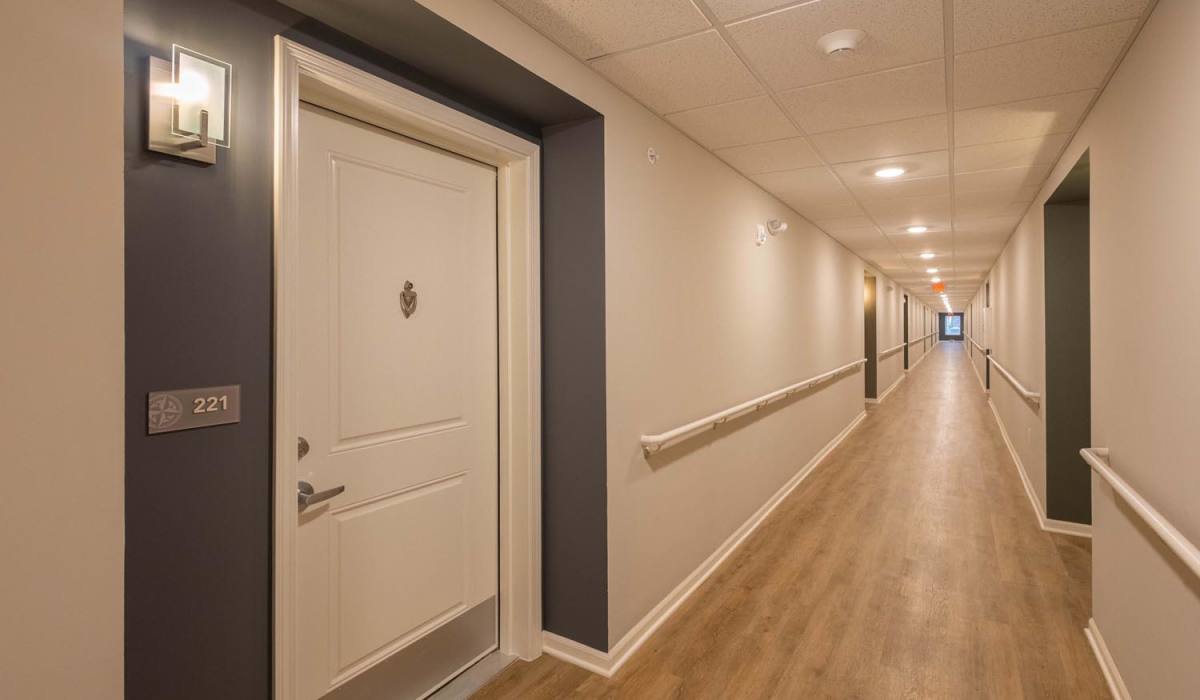 Bright hallway with wood-style flooring at Juniper Crossing II in Columbus, Ohio
