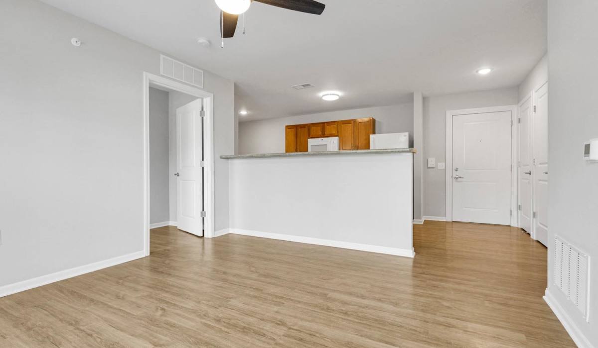 A living room with wood-style flooring at Lockbourne Greene in Columbus, Ohio