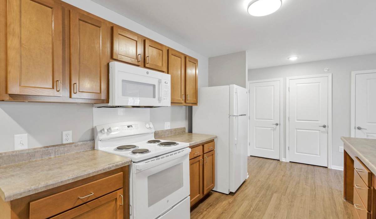 A spacious kitchen with white appliances at Lockbourne Greene in Columbus, Ohio