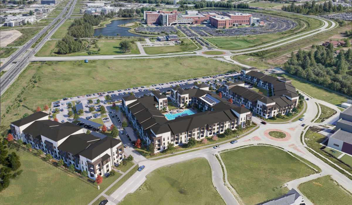 Apartment buildings with a pool and parking at The Heights at Materra in Baton Rouge, Louisiana