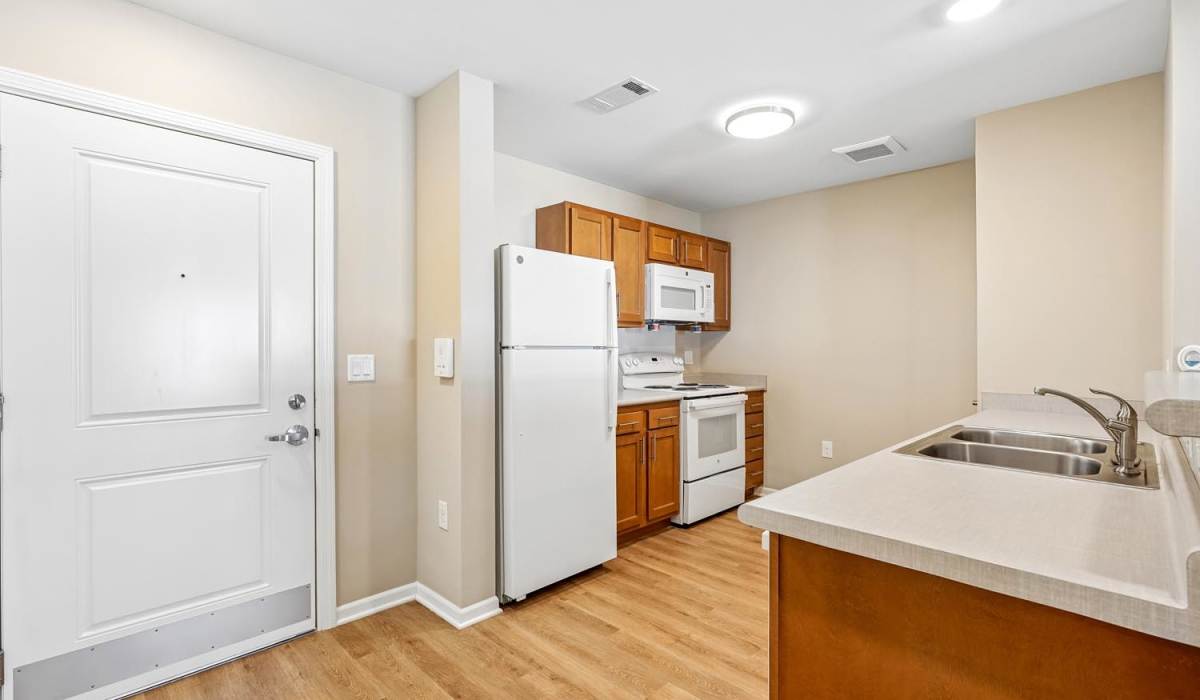 View of the kitchen with a refrigerator at Juniper Crossing I in Columbus, Ohio 