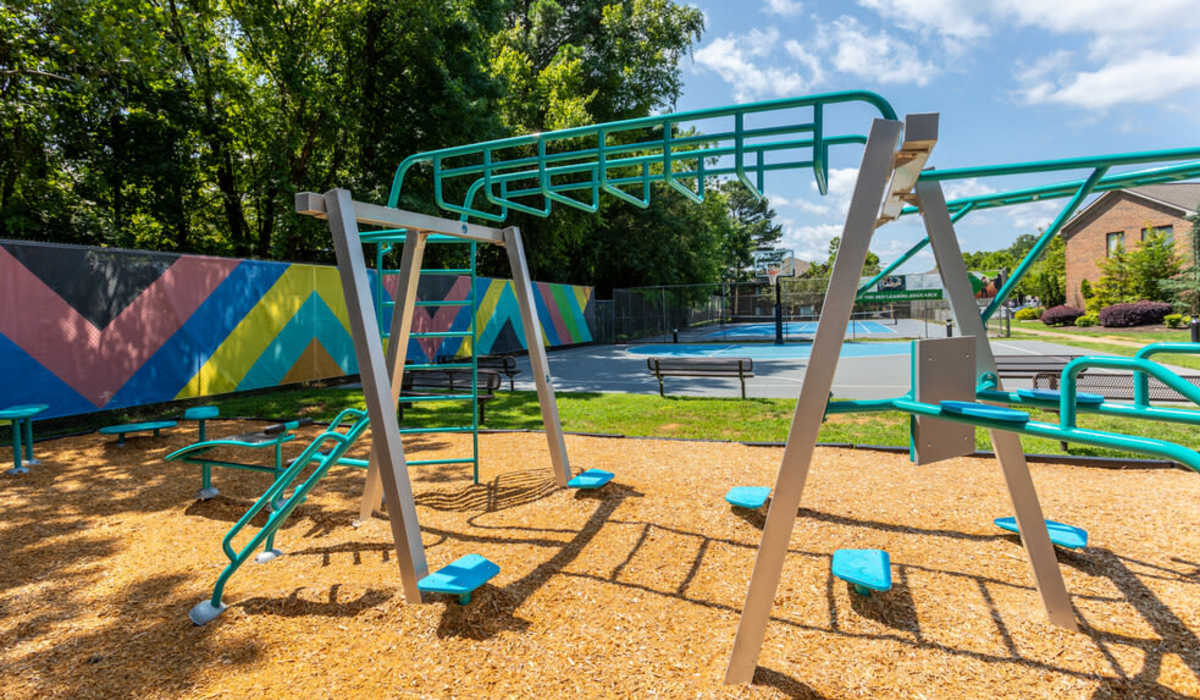 Colorful wall mural with playground equipment at Collins Crossing Apartments in Carrboro, North Carolina