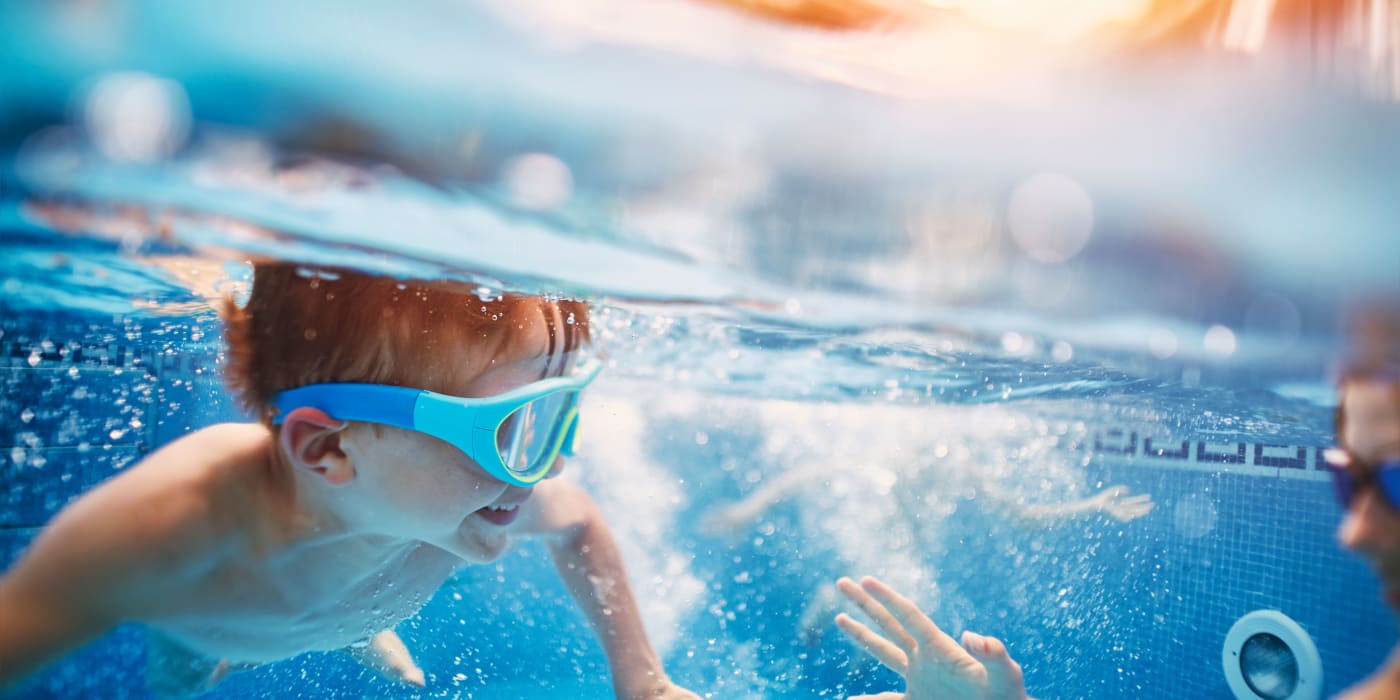 Kids swimming in the pool at Westminster Oaks Townhomes in Springfield, Virginia