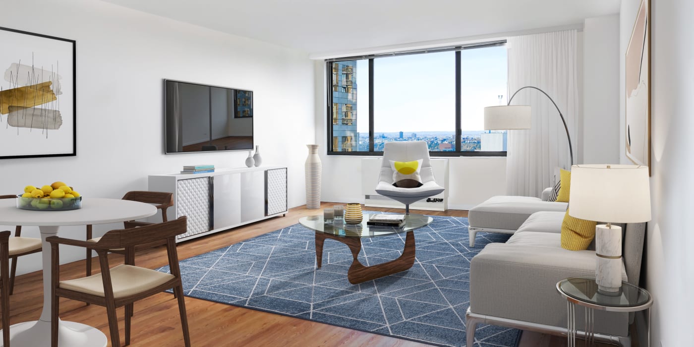 Spacious living room area with modern looking furniture at Carnegie Mews in New York, New York