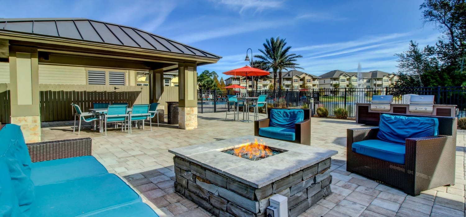 Poolside firepit and outdoor lounge at Seagrass Apartments in Jacksonville, Florida