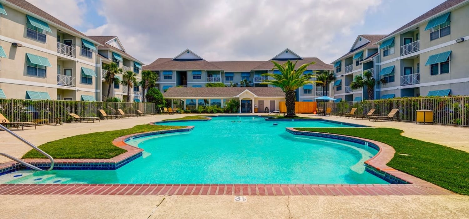 Beautiful skies and a spacious pool Harborside Apartment Homes in Slidell, Louisiana