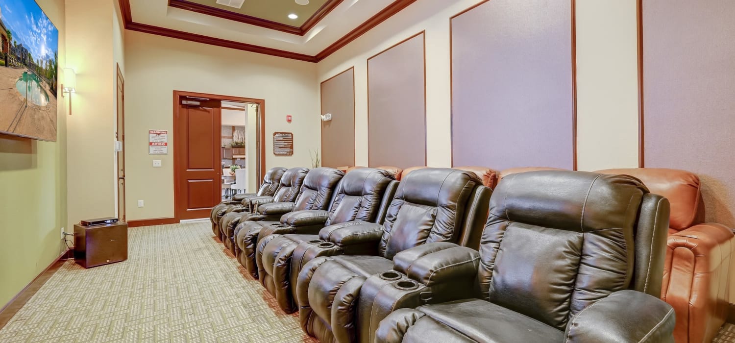 Theatre room with leather recliners and a big screen tv at Chateau Mirage Apartment Homes in Lafayette, Louisiana