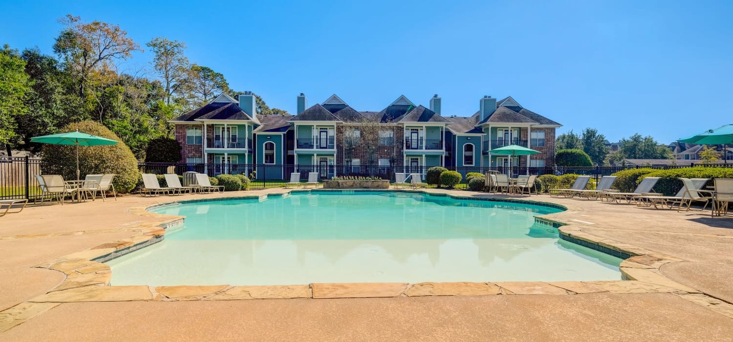 Exterior pool view and patio area at Audubon Lake Apartments in Lafayette, LA