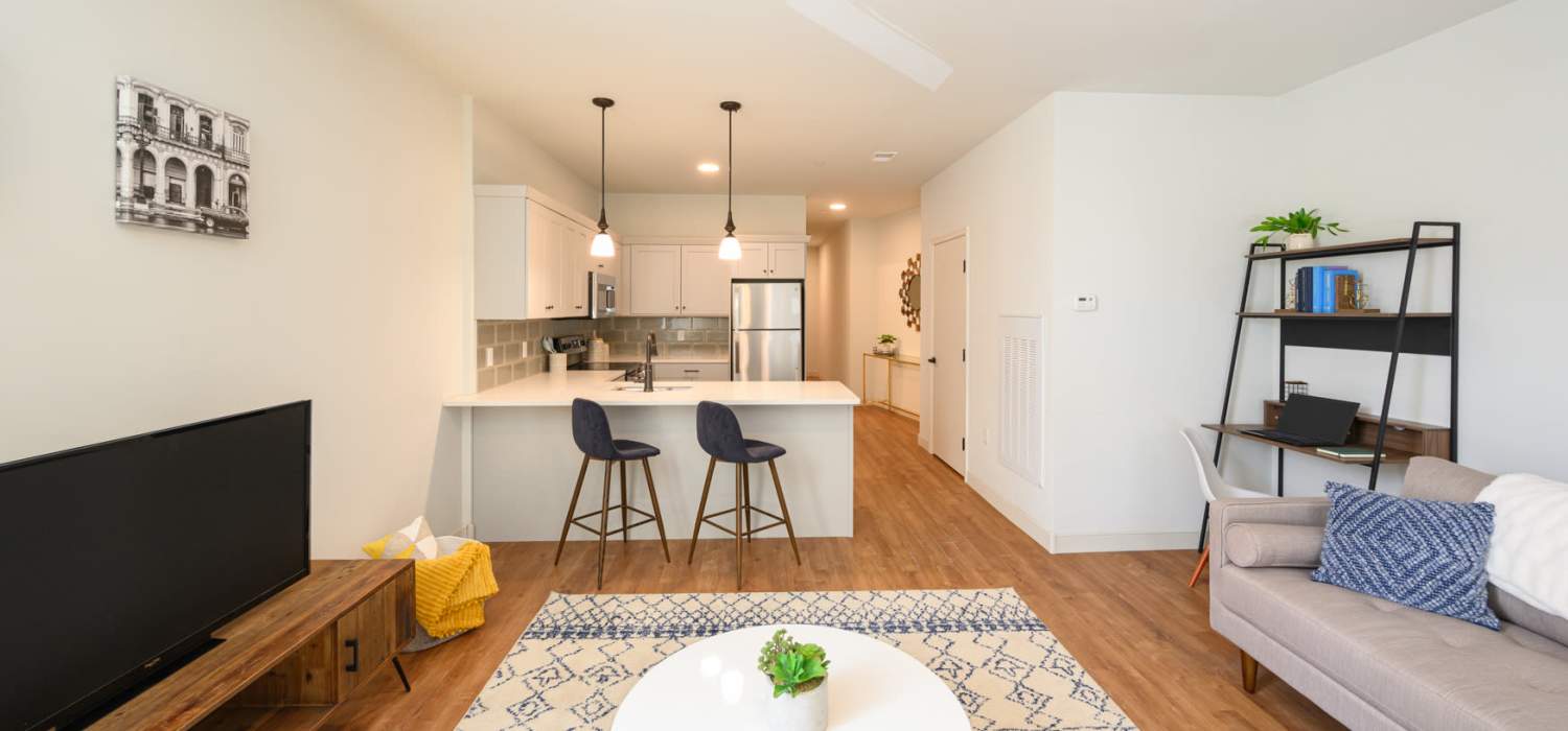 Living room with wood-style flooring at Lincoln Square in Wilmington, Delaware