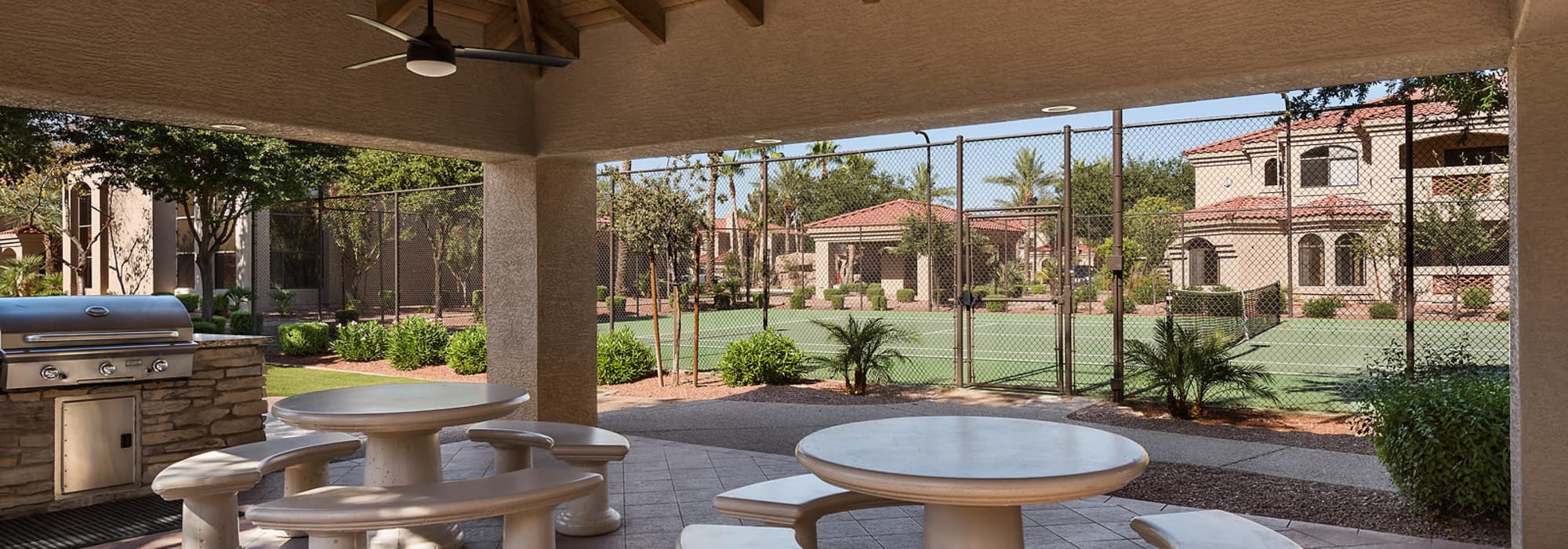 BBQ area and tennis court at San Cervantes in Chandler, Arizona
