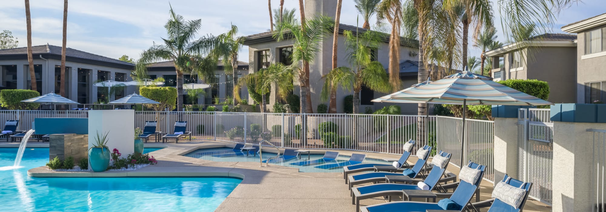 Resort style swimming pool that has lounge chairs all around it for residents and friends to use at Elite North Scottsdale in Scottsdale, Arizona