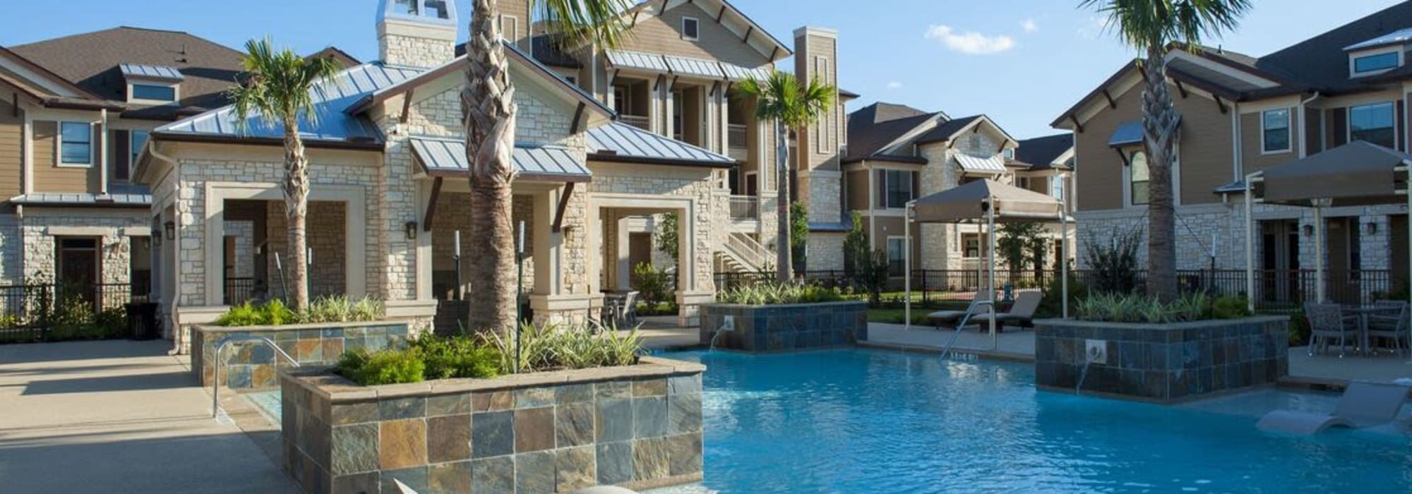 Pool with palm trees at The Crossing at Katy Ranch in Katy, Texas