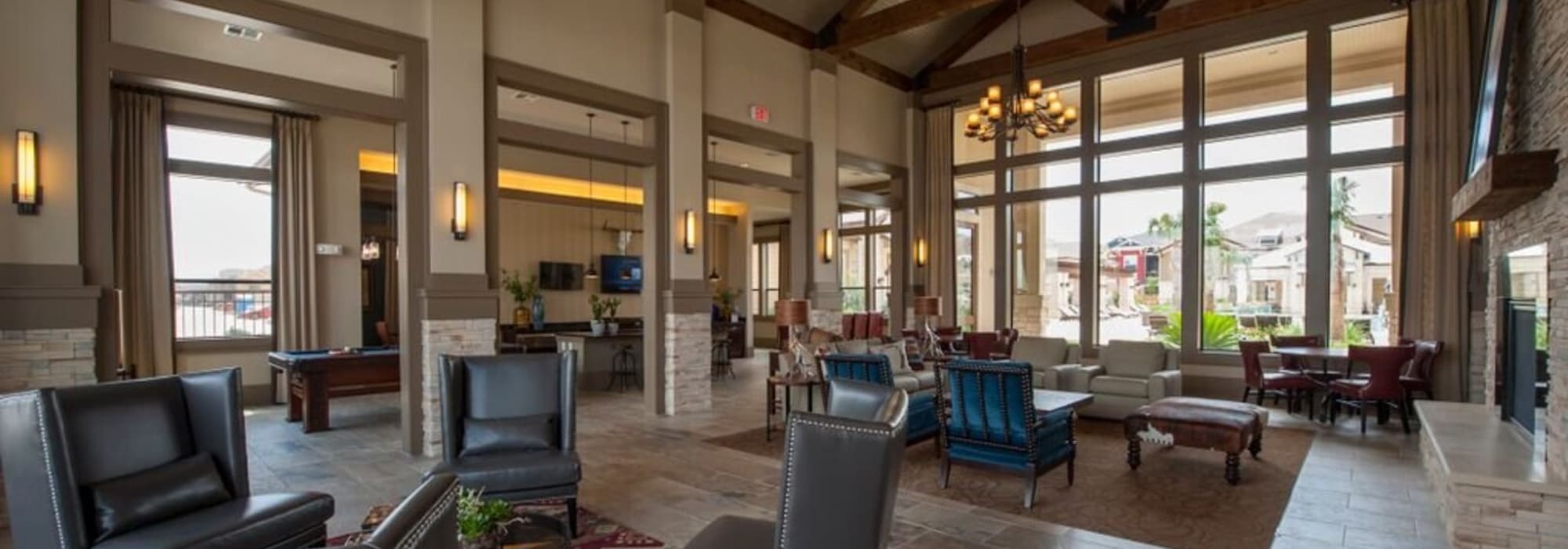 community clubhouse with huge windows looking out to the pool at The Crossing at Katy Ranch in Katy, Texas